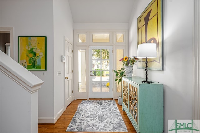 foyer entrance featuring baseboards and wood finished floors