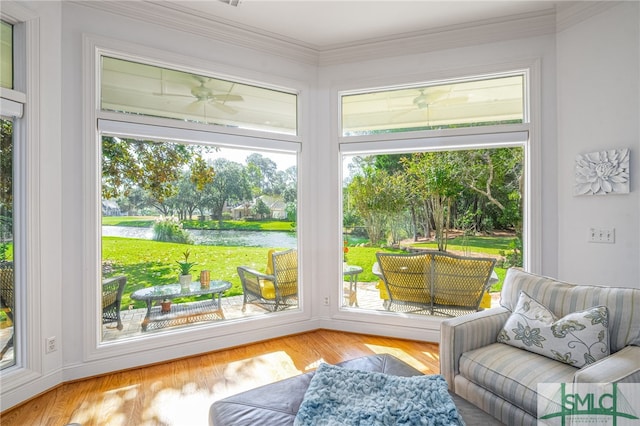 sunroom / solarium featuring a water view and ceiling fan