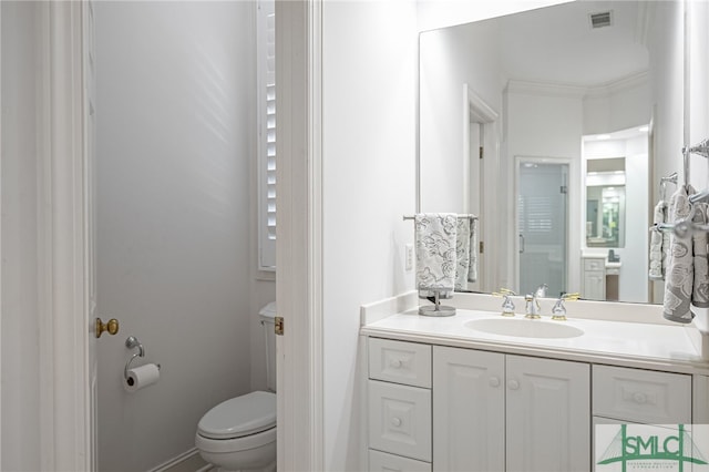 bathroom with visible vents, crown molding, vanity, and toilet