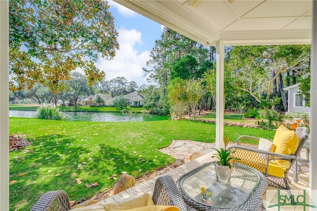 view of yard featuring a water view and a patio area