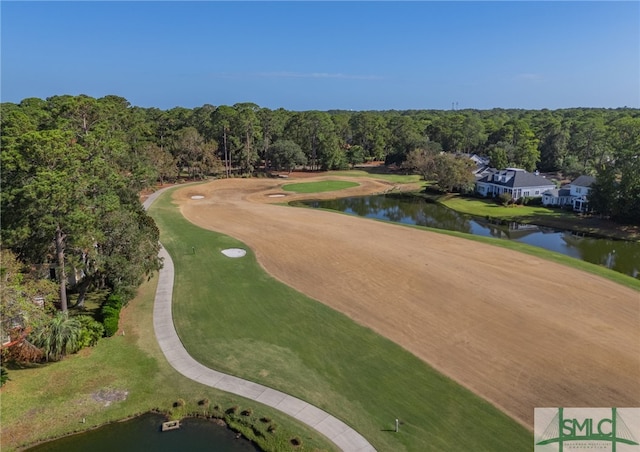 aerial view featuring golf course view, a water view, and a wooded view