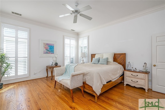 bedroom with light wood-style flooring, ornamental molding, baseboards, and ceiling fan