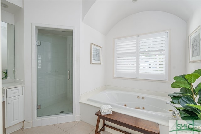bathroom with a stall shower, tile patterned flooring, and a whirlpool tub