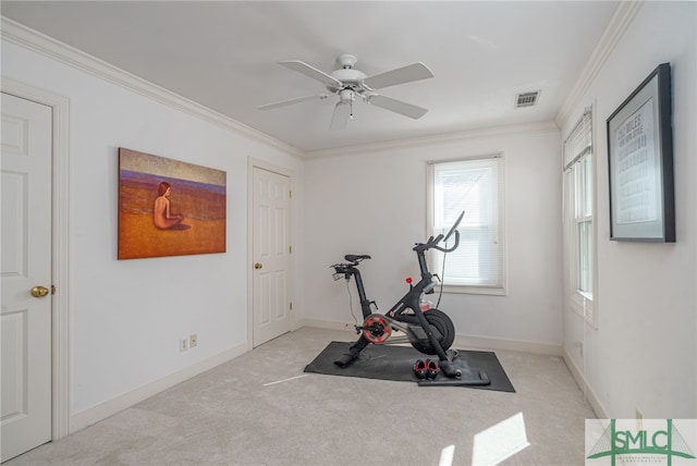 workout area featuring ornamental molding, light carpet, baseboards, and a ceiling fan