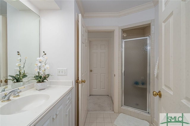 bathroom with tile patterned floors, a stall shower, vanity, and crown molding