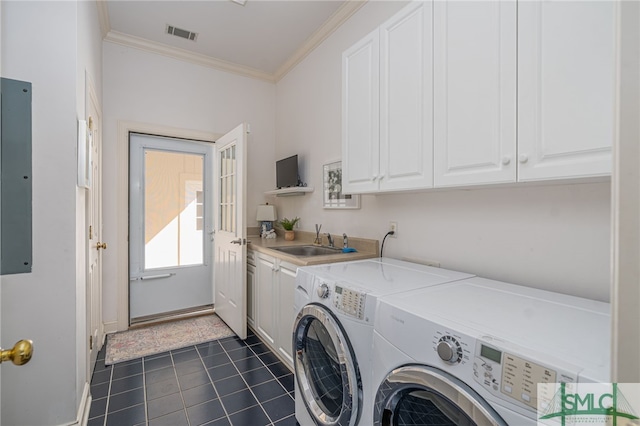 washroom featuring cabinet space, washer and clothes dryer, crown molding, and dark tile patterned flooring