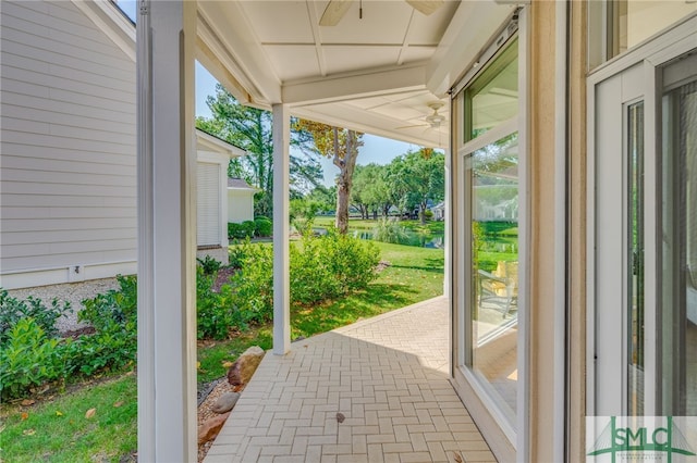 view of patio / terrace featuring a ceiling fan and a water view