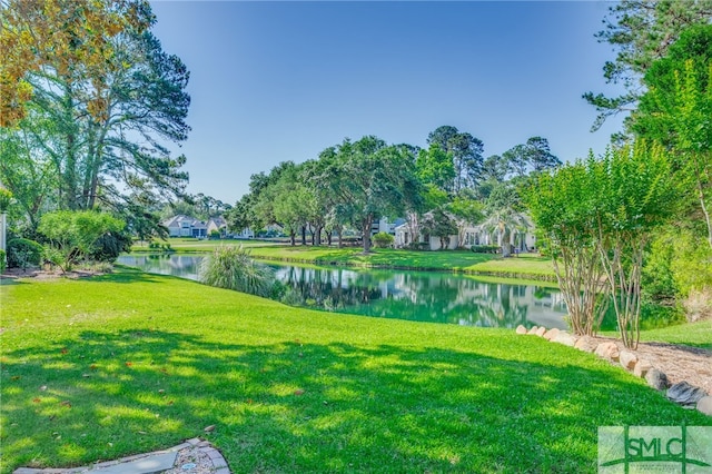 surrounding community featuring a water view and a yard