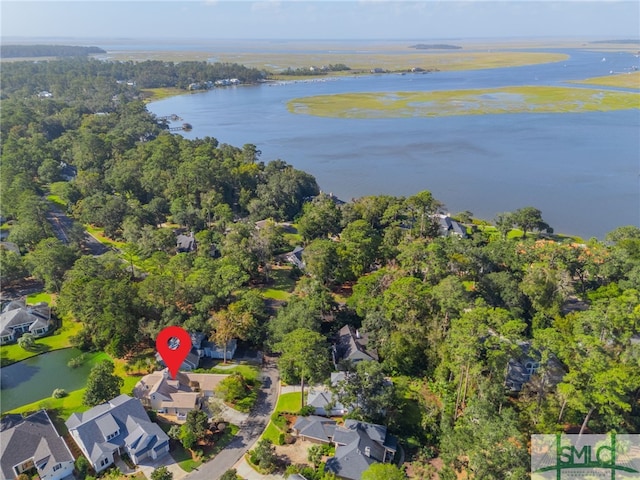 aerial view of property's location with a large body of water and nearby suburban area
