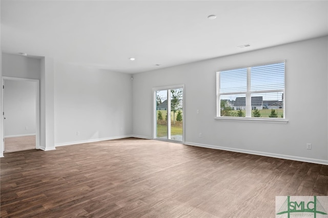 spare room with dark wood-type flooring