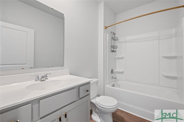 full bathroom featuring toilet, washtub / shower combination, vanity, and hardwood / wood-style flooring