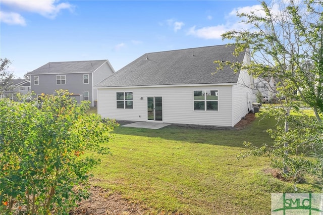 back of property with a lawn and a patio