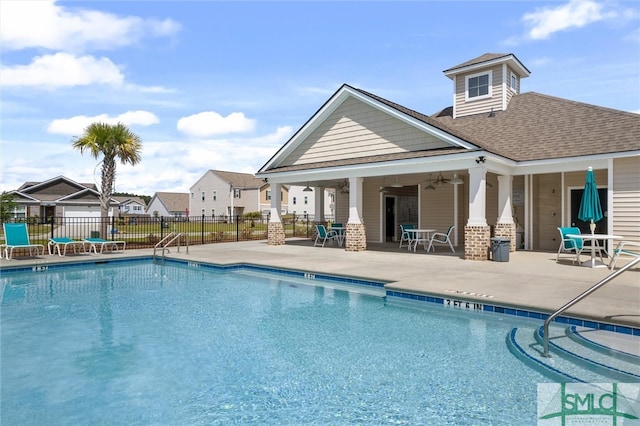 view of swimming pool featuring ceiling fan and a patio area