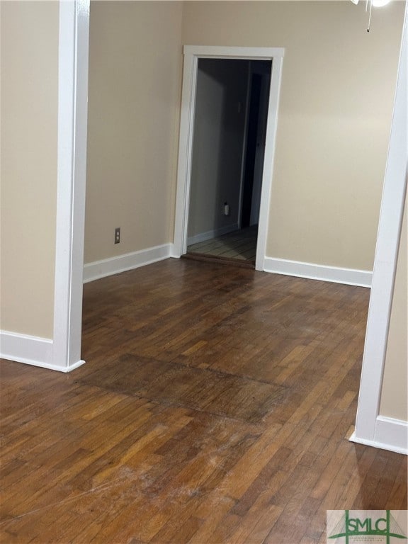 empty room featuring dark hardwood / wood-style flooring and ceiling fan