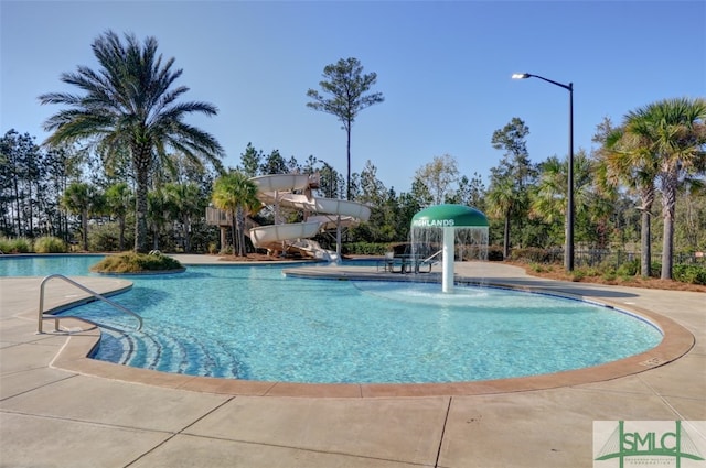 view of pool featuring a patio, pool water feature, and a water slide