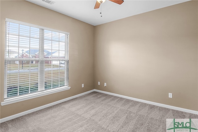 carpeted spare room with ceiling fan