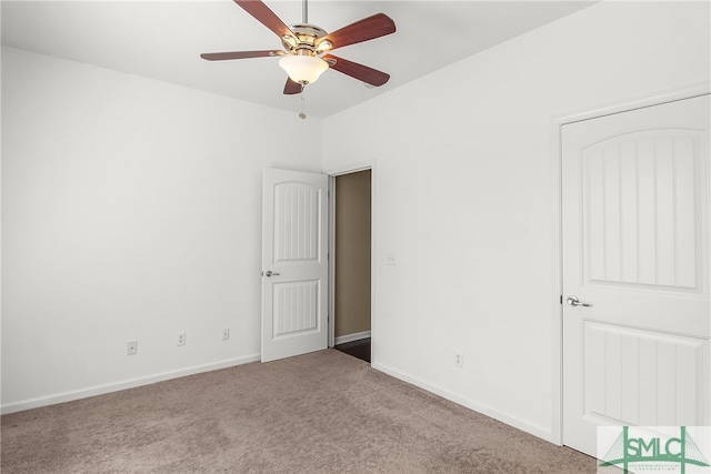 unfurnished room with ceiling fan and light carpet