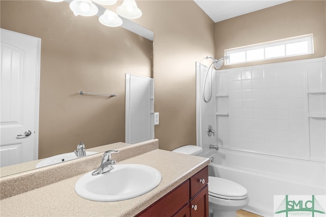 full bathroom featuring washtub / shower combination, vanity, and toilet