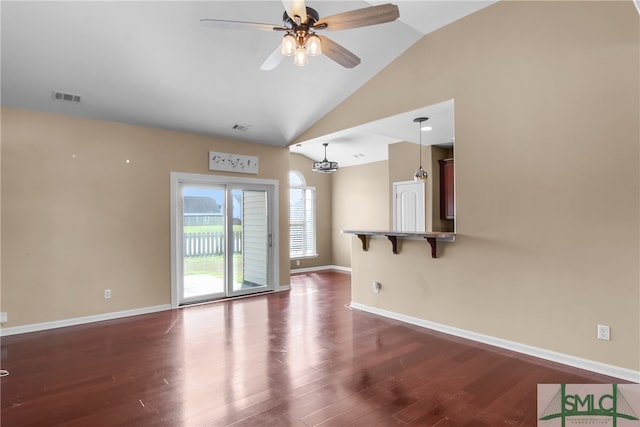 unfurnished room featuring dark hardwood / wood-style flooring, vaulted ceiling, and ceiling fan