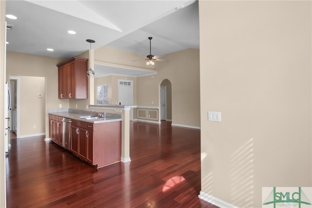 kitchen with dark wood-type flooring, sink, stainless steel dishwasher, ceiling fan, and pendant lighting