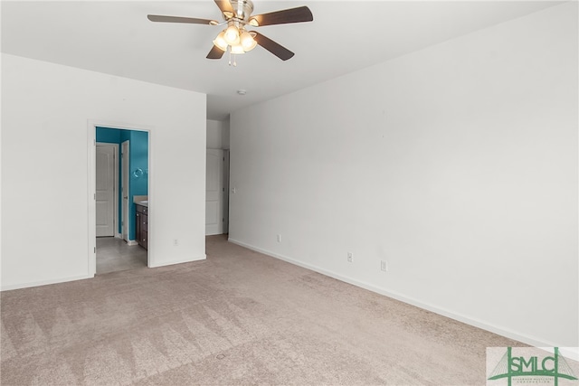 unfurnished bedroom with ceiling fan, connected bathroom, and light carpet