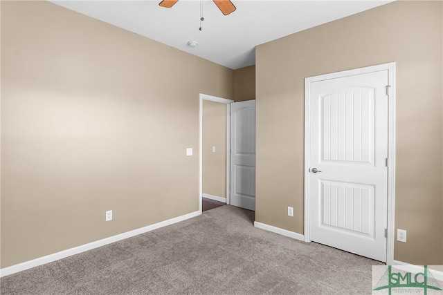 unfurnished bedroom with light colored carpet and ceiling fan