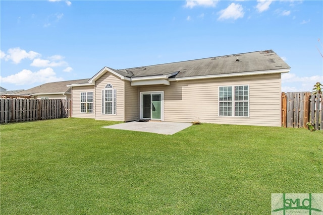 rear view of property with a patio and a lawn