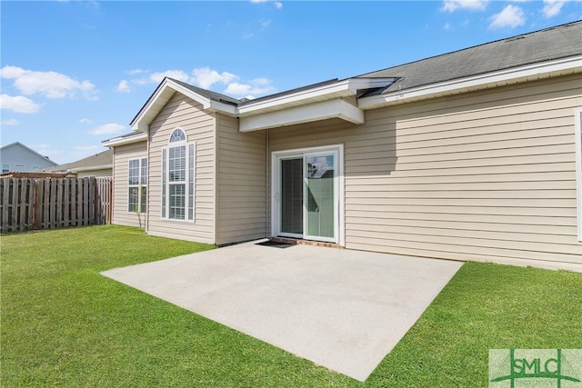 back of house featuring a patio and a yard