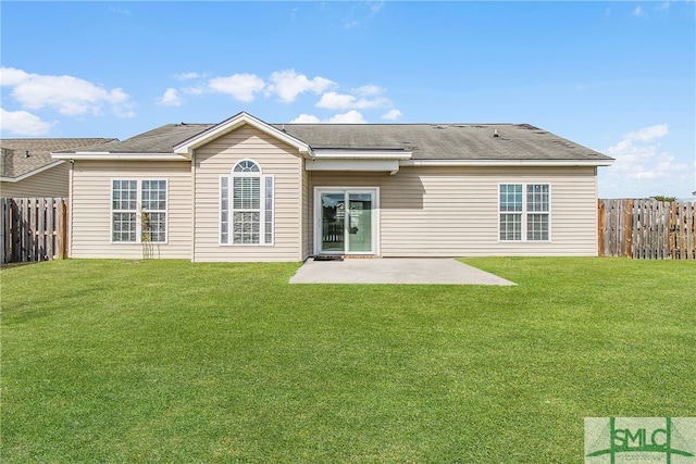 rear view of house featuring a patio and a yard