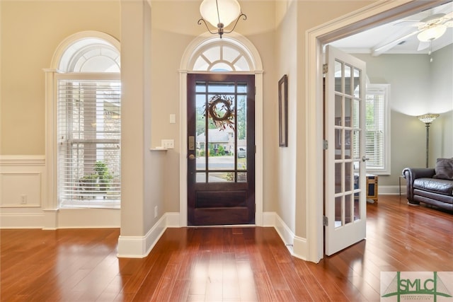 entryway with a wealth of natural light, ceiling fan, and dark wood-type flooring