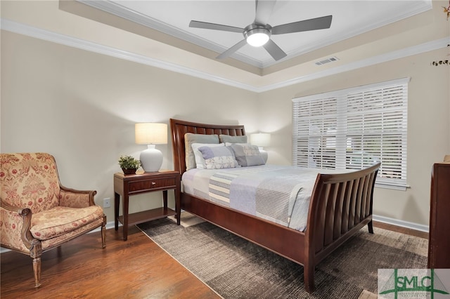 bedroom with ornamental molding, dark hardwood / wood-style flooring, and ceiling fan