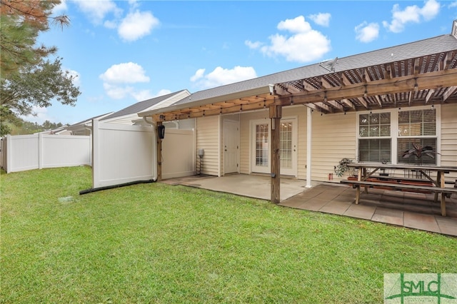 back of house featuring a lawn, a patio, and a pergola