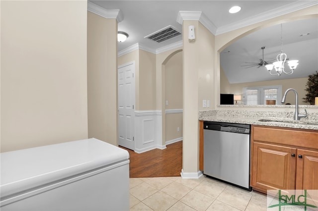 kitchen with crown molding, light tile patterned floors, light stone countertops, sink, and stainless steel dishwasher