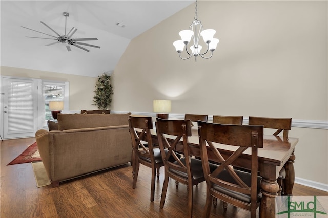 dining space with dark hardwood / wood-style flooring, high vaulted ceiling, and ceiling fan with notable chandelier