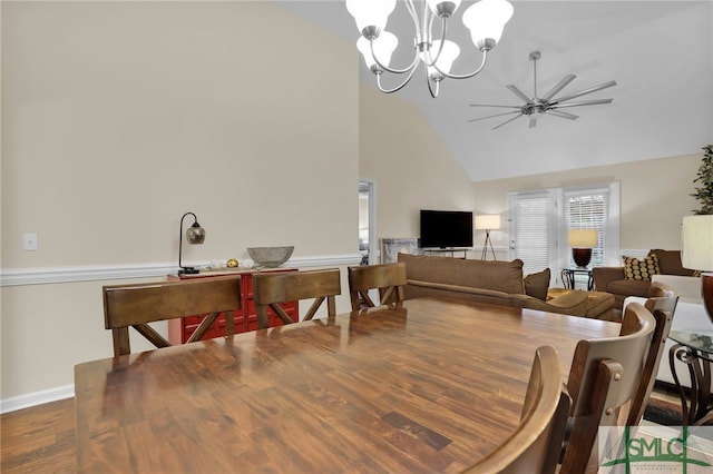 dining room featuring high vaulted ceiling, wood-type flooring, and ceiling fan with notable chandelier