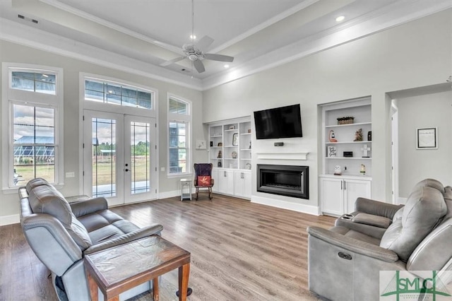 1495 Lillie Hagan Rd, Brooklet, GA 30415 - living room with light wood-type flooring, french doors, a ceiling fan, crown molding, and healthy amount of natural light