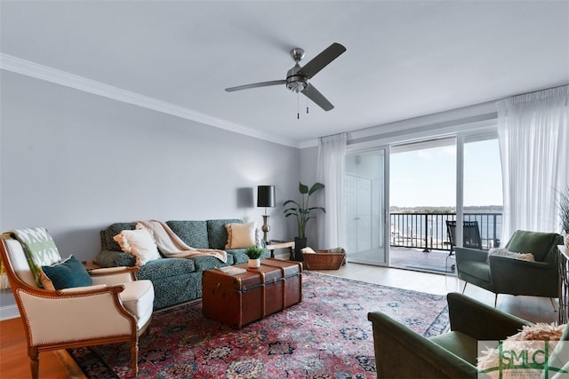 living room featuring wood-type flooring, a water view, ornamental molding, and ceiling fan