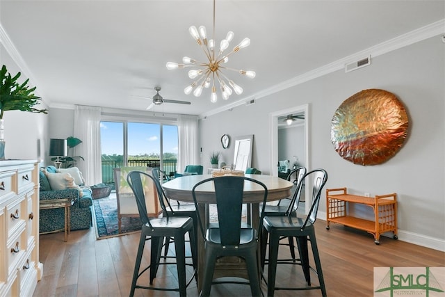 dining area featuring hardwood / wood-style flooring, crown molding, and ceiling fan with notable chandelier