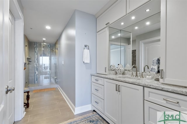 bathroom with walk in shower and vanity