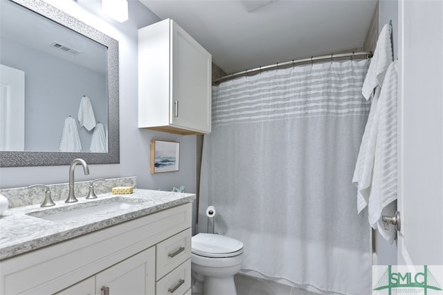 bathroom with vanity, curtained shower, and toilet