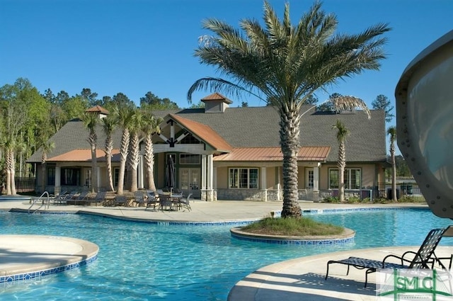 pool with fence and a patio area