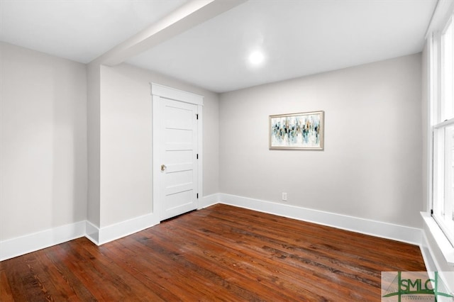 empty room with dark wood-type flooring