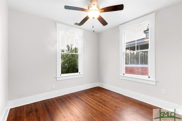 spare room with hardwood / wood-style floors and ceiling fan