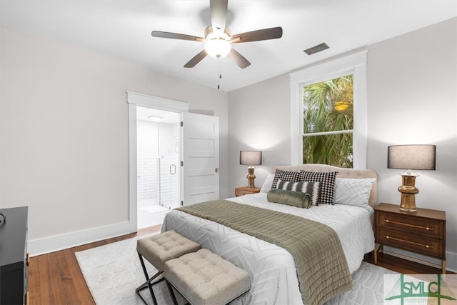 bedroom featuring dark wood-type flooring, ceiling fan, and ensuite bathroom