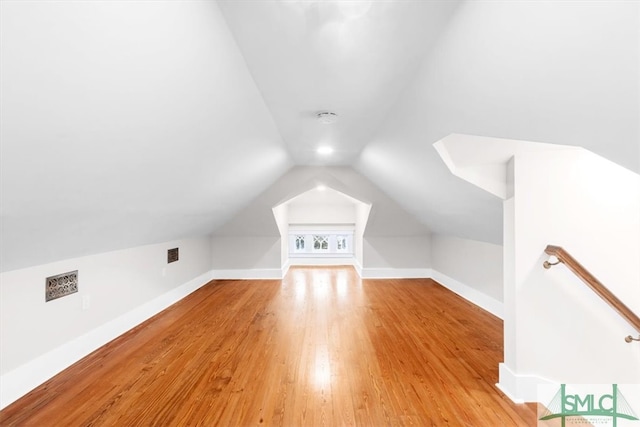 bonus room featuring lofted ceiling and light hardwood / wood-style floors