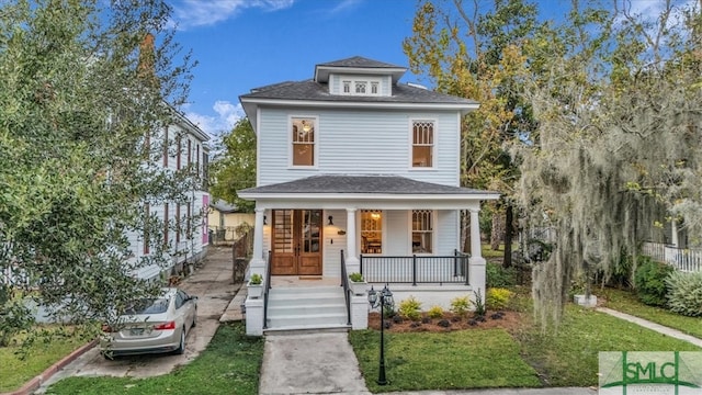 view of front of property with a front yard and covered porch