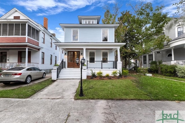 view of front of property featuring a front lawn and covered porch