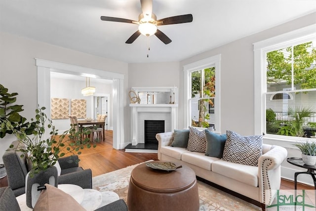 living room with ceiling fan and light hardwood / wood-style flooring