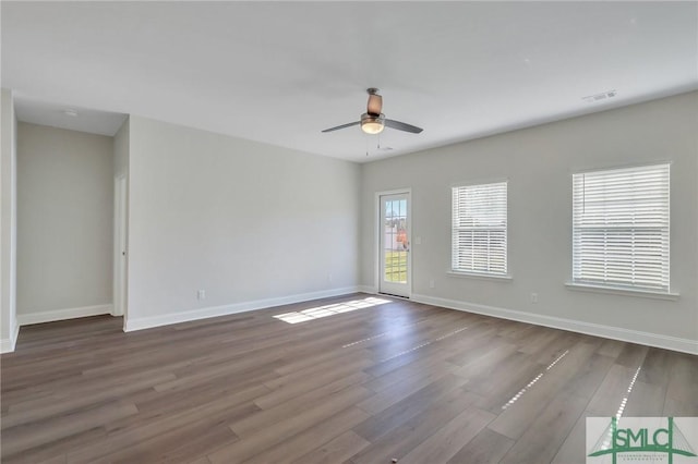 unfurnished room featuring dark hardwood / wood-style flooring and ceiling fan