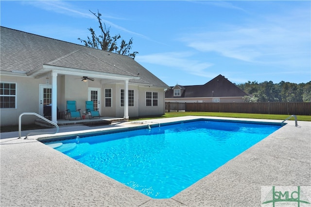 view of swimming pool with ceiling fan and a patio